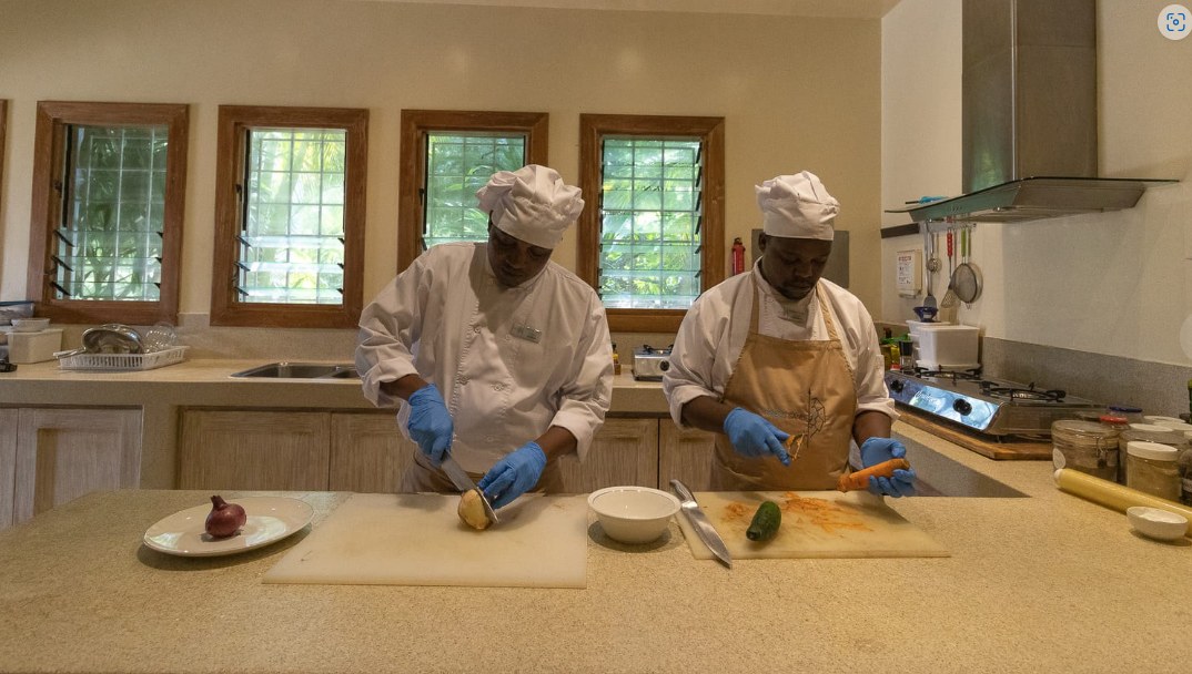Two Zuri chefs preparing fresh vegetables in the kitchen